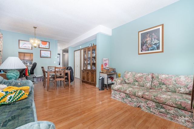 living room with a notable chandelier and hardwood / wood-style flooring