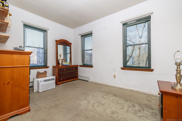 bedroom featuring light carpet, baseboard heating, and multiple windows