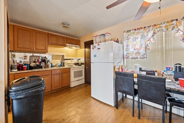 kitchen featuring a textured ceiling, ceiling fan, white appliances, and light wood-type flooring