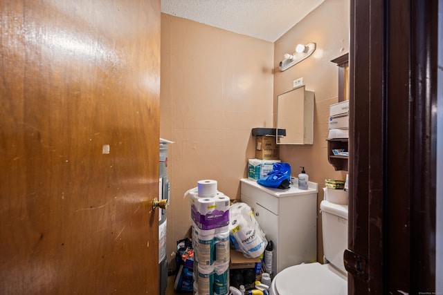 bathroom with a textured ceiling and toilet