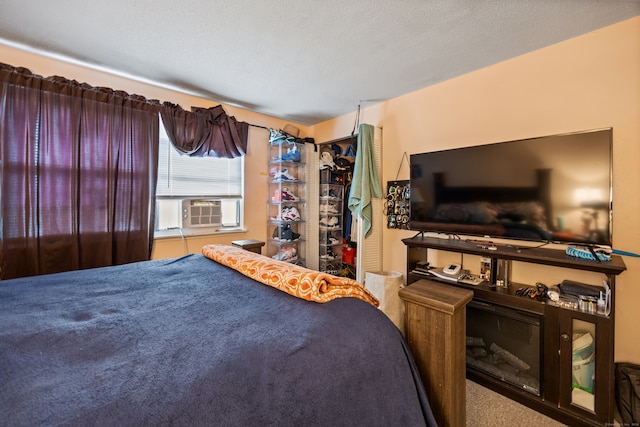 carpeted bedroom featuring a textured ceiling