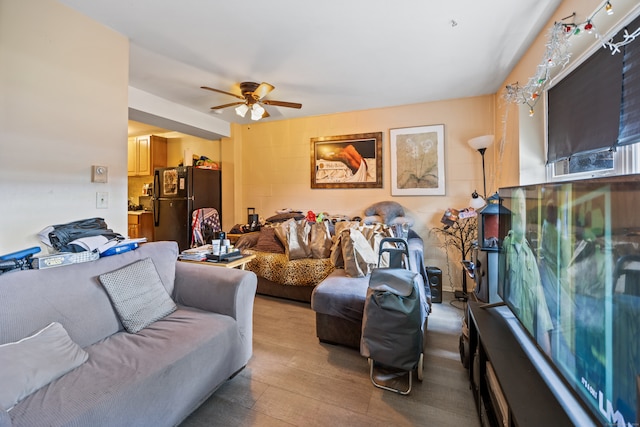 living room with light wood-type flooring and ceiling fan