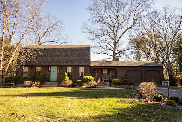 single story home featuring a front yard and a garage