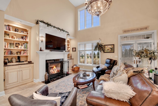 living room featuring built in shelves, high vaulted ceiling, an inviting chandelier, and light tile patterned flooring