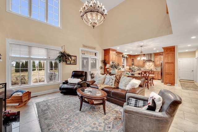 tiled living room featuring a notable chandelier and a high ceiling