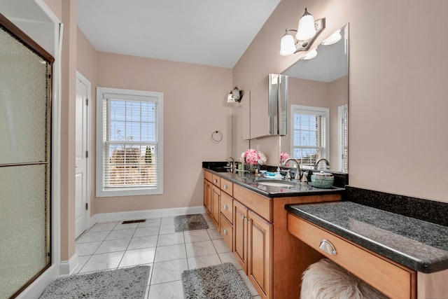 bathroom with tile patterned flooring, vanity, walk in shower, and a notable chandelier