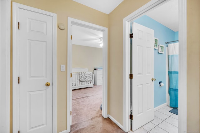 hallway featuring light carpet