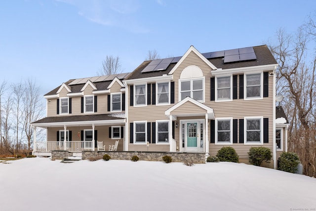 colonial home featuring solar panels and covered porch