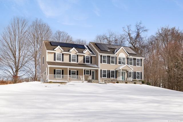 view of front of house with covered porch and solar panels