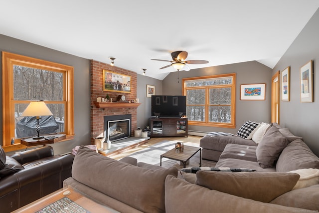 living room with vaulted ceiling, a fireplace, wood-type flooring, a baseboard radiator, and ceiling fan