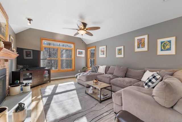 living room featuring lofted ceiling, a fireplace, light hardwood / wood-style floors, and a baseboard heating unit