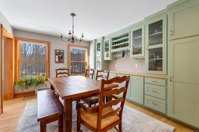 dining room featuring a notable chandelier and light wood-type flooring