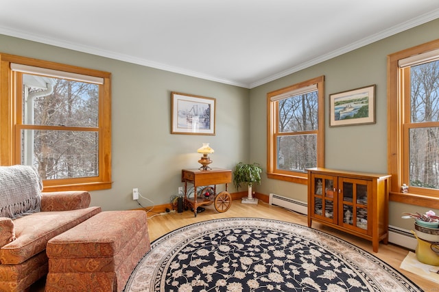 sitting room with baseboard heating, crown molding, and light hardwood / wood-style floors