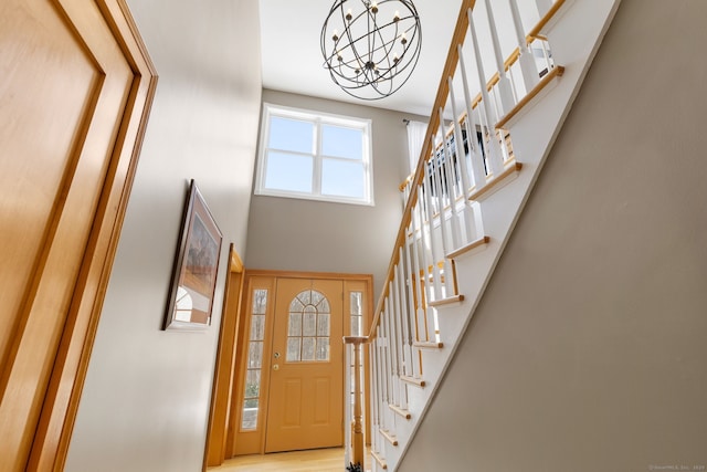 foyer entrance featuring a notable chandelier and a high ceiling