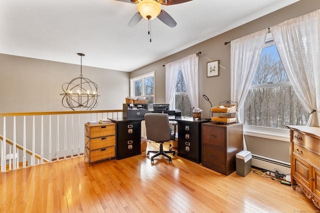 home office with baseboard heating, ceiling fan with notable chandelier, and light wood-type flooring