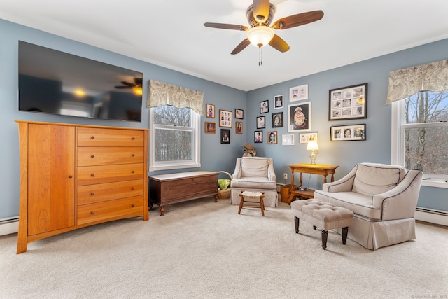 sitting room with ceiling fan, a healthy amount of sunlight, and carpet flooring