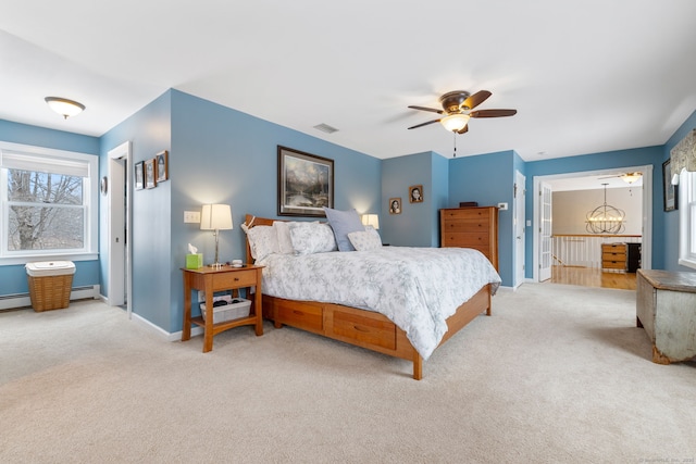 bedroom featuring a baseboard radiator, ceiling fan with notable chandelier, and light carpet