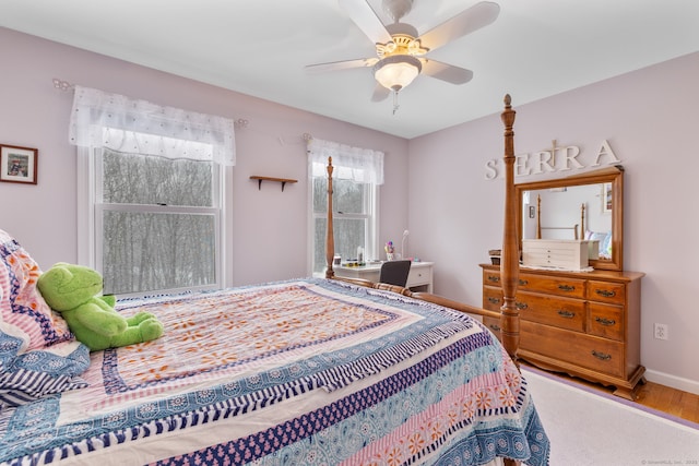 bedroom with ceiling fan and hardwood / wood-style floors