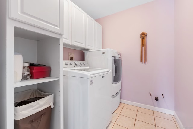 laundry area with cabinets, light tile patterned flooring, and independent washer and dryer