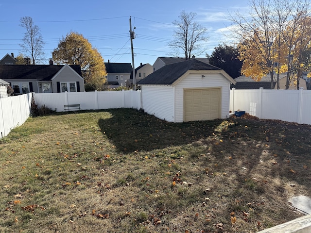 view of yard with a garage and an outdoor structure