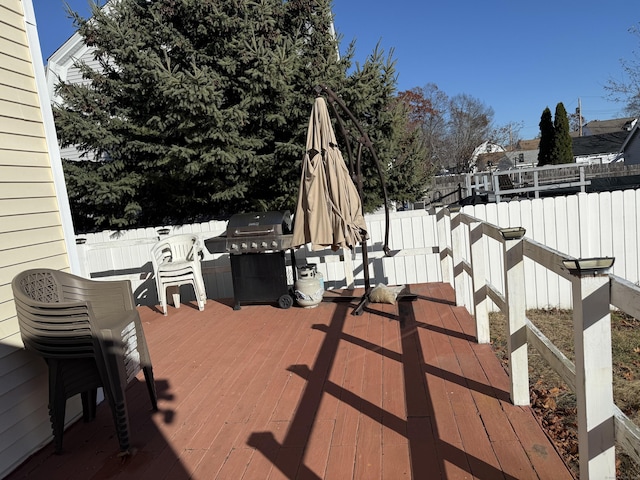 wooden terrace with a grill