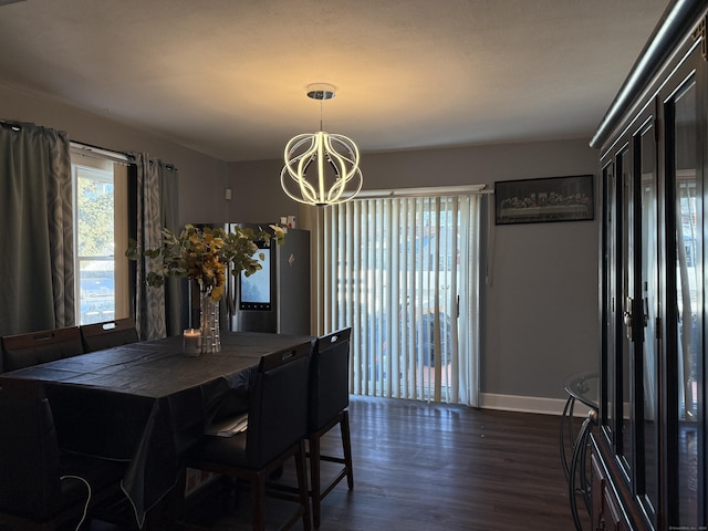 dining space with dark hardwood / wood-style flooring and an inviting chandelier