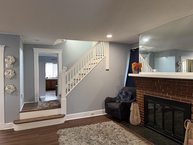 living room with dark hardwood / wood-style flooring and a fireplace