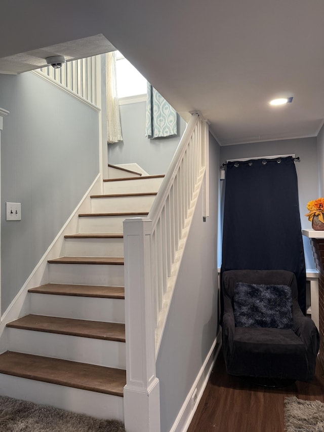 staircase with hardwood / wood-style floors