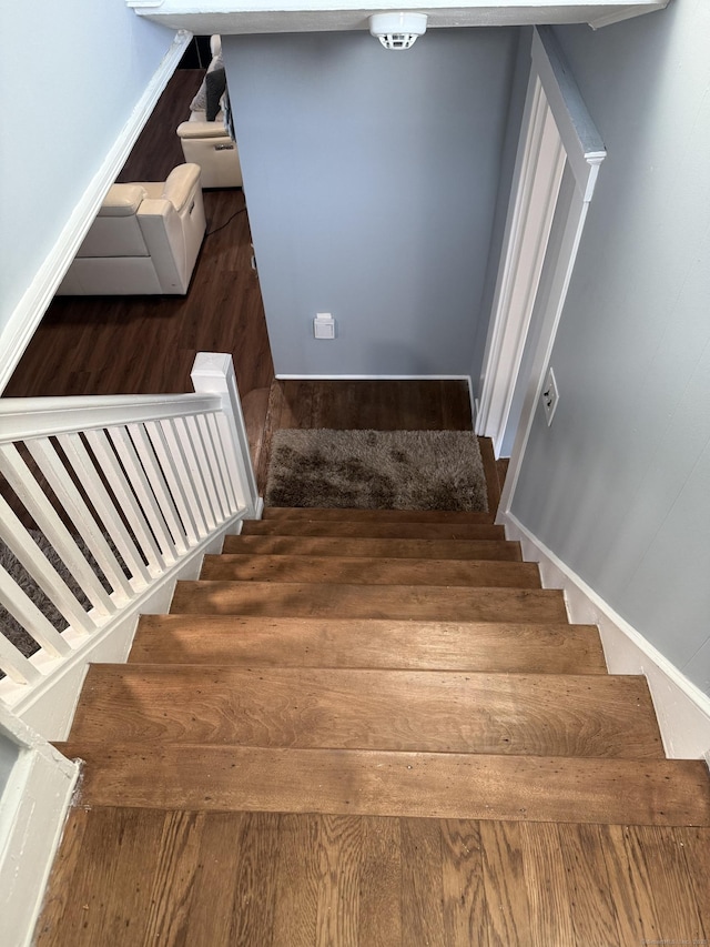 stairway featuring hardwood / wood-style floors