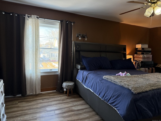 bedroom with ceiling fan and light hardwood / wood-style flooring