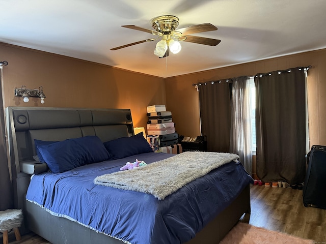 bedroom featuring hardwood / wood-style flooring and ceiling fan