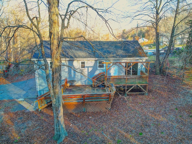 back of house featuring a wooden deck