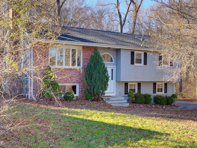 raised ranch with a front lawn