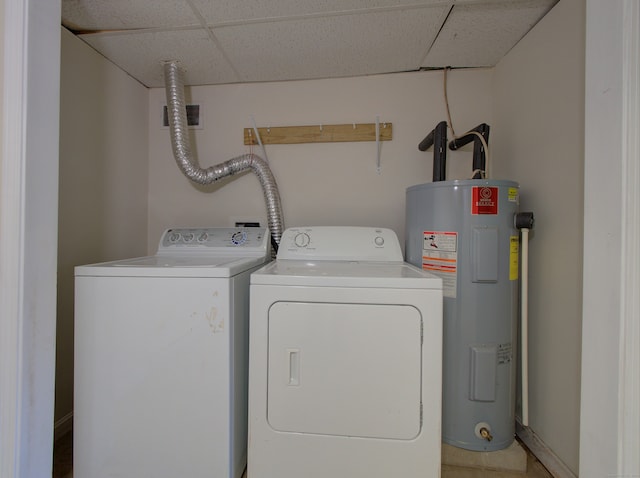 clothes washing area featuring washing machine and dryer and water heater