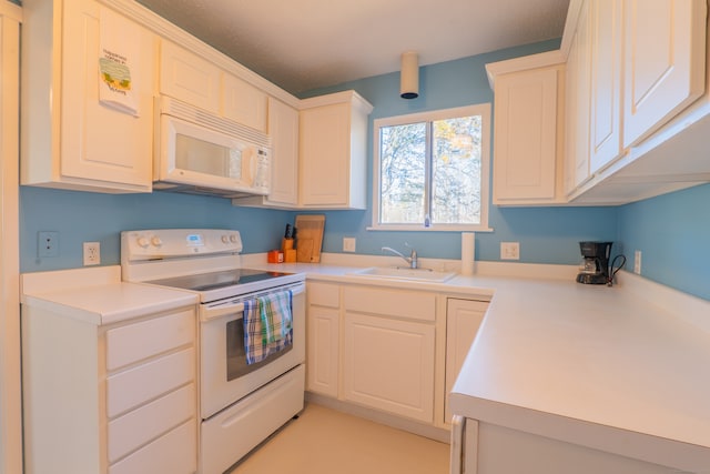 kitchen featuring white cabinets, white appliances, and sink