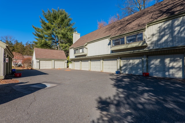 exterior space with a garage and an outdoor structure