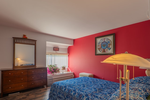 bedroom with dark wood-type flooring