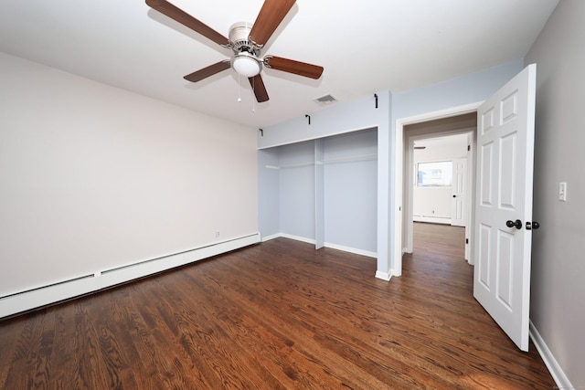 unfurnished bedroom with a closet, dark hardwood / wood-style floors, a baseboard radiator, and ceiling fan