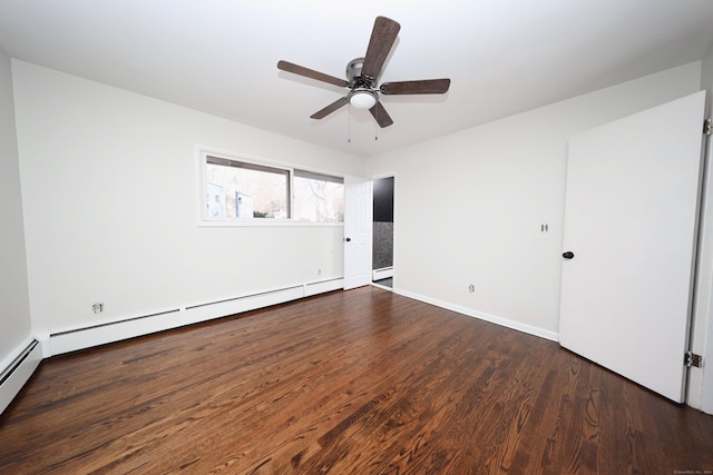 spare room featuring ceiling fan, baseboard heating, and dark wood-type flooring