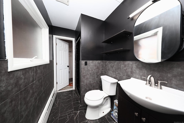 bathroom featuring vanity, a baseboard radiator, toilet, and tile walls