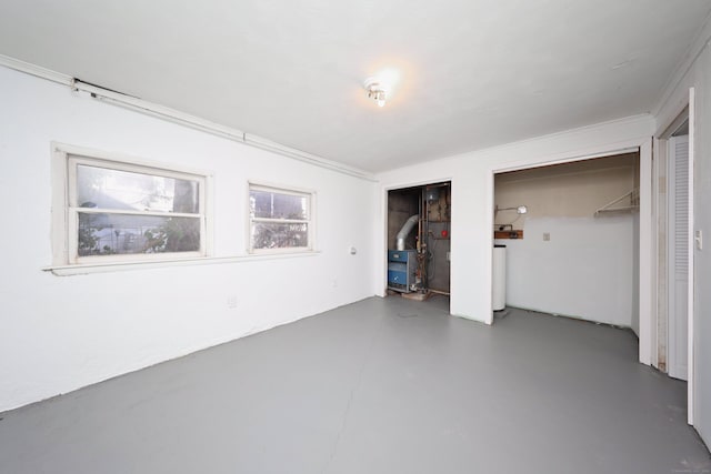 unfurnished bedroom with concrete floors and ornamental molding