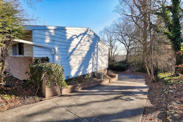 view of side of home featuring central AC