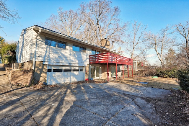 view of front of property featuring a garage and a deck