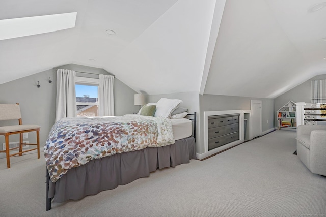 bedroom with lofted ceiling with skylight and light carpet