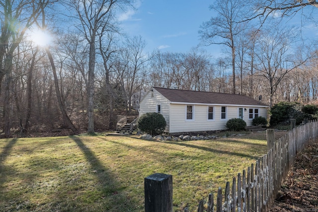 view of side of property with a yard