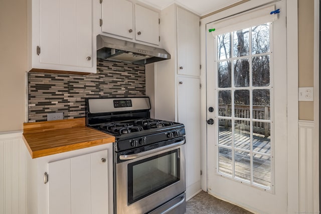 kitchen featuring white cabinets, stainless steel gas stove, wooden counters, and tasteful backsplash