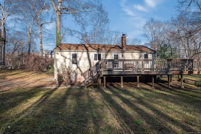 rear view of property with a lawn and a deck