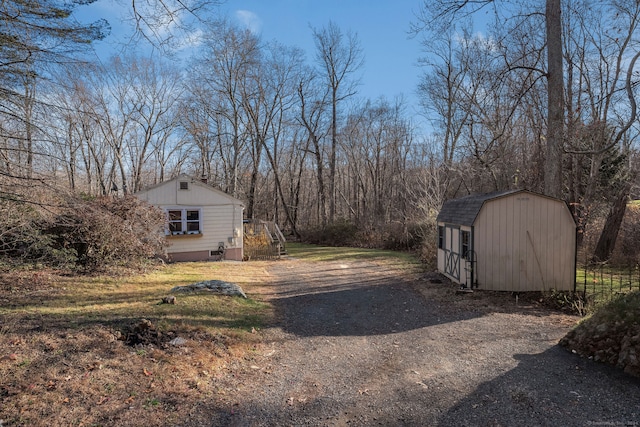 view of side of home with a storage shed