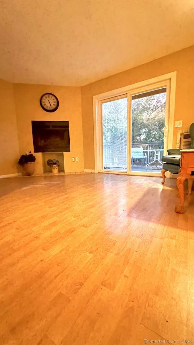 unfurnished living room with wood-type flooring