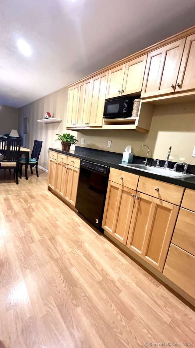 kitchen featuring sink, black appliances, light brown cabinets, and light hardwood / wood-style floors